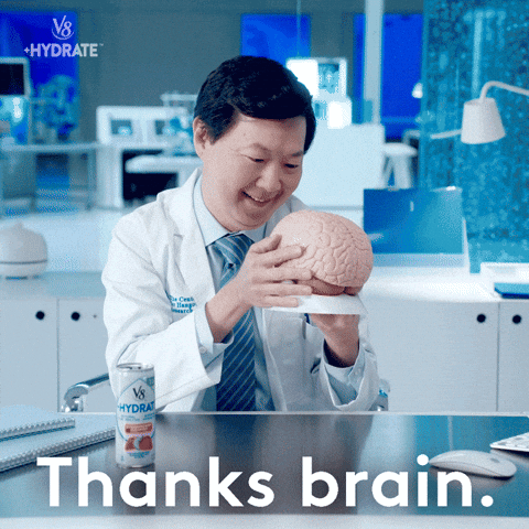 GIF of a scientists Ken Jeong kissing a brain.